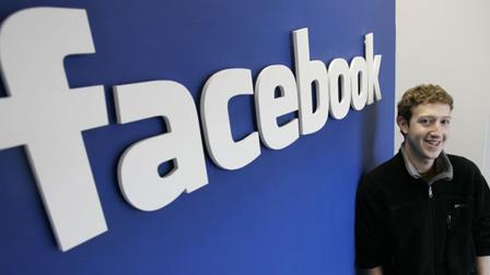 In this Feb. 5, 2007 file photo, Facebook CEO Mark Zuckerberg poses at his office in Palo Alto, Calif.