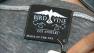 A tag on a clothing item shows that it is made in America.