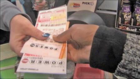 A cashier hands a woman Powerball tickets in this undated file photo.