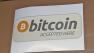 A sign advertising Bitcoin is seen.