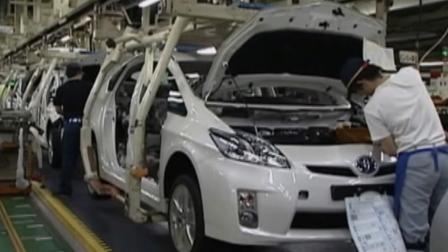 An employee works on a Toyota Prius vehicle in this undated file photo.