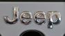 This Feb. 14, 2013 photo shows a Jeep logo on the grill of a Jeep Wrangler at the 2013 Pittsburgh Auto Show in Pittsburgh.