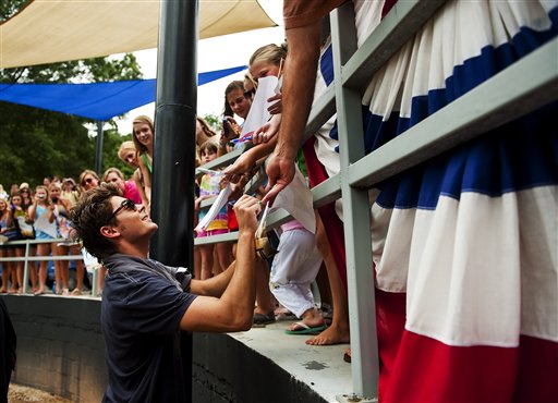 Zac Efron signs autographs for fans as he promotes his new film 'Charlie St. Cloud' at the Dan Perez Baseball Camp at Murphey Candler Baseball Park on Tuesday, July 13, 2010, in Atlanta.