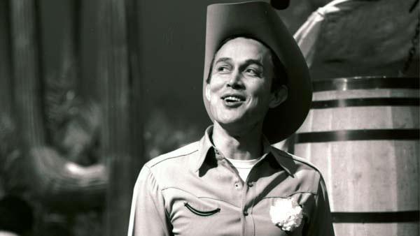 In this April 2, 1964 file photo, Jimmy Dean smiles while he gets ready for a taping of his show 