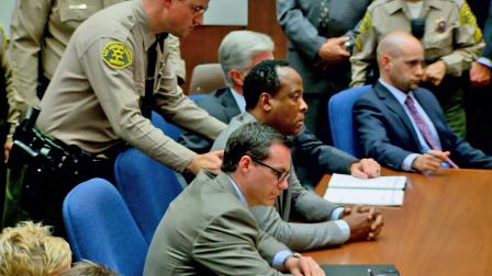 A sheriff is seen in court preparing to take Dr. Conrad Murray into custody in this undated file photo.