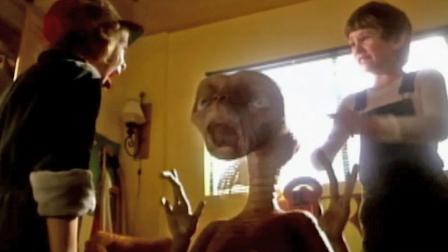 A still from footage of E.T.: The Extra-Terrestrial shows character Gertie, played by a young Drew Barrymore (left), screaming as she first encounters an alien named E.T. (center) as introduced by her brother Elliot, played by Henry Thomas (right).
