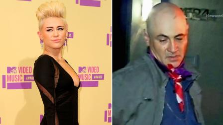 A suspect is detained by police Saturday, Sept. 8, 2012 after he allegedly made his way onto the Studio City property of singer Miley Cyrus, seen on the left at the MTV Video Music Awards on Thursday, Sept. 6, 2012.