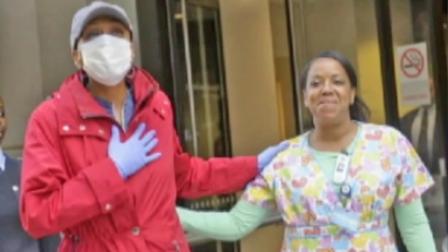 Good Morning America co-host Robin Roberts steps out of a New York hospital and takes her first breath of fresh air on Wednesday, Oct. 10, 2012.