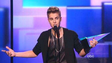 Justin Bieber accepts his first award of the night, Favorite Male Artist - Pop / Rock, at the American Music Awards in downtown Los Angeles on Sunday, Nov. 18, 2012.