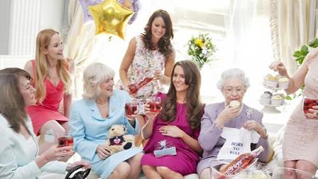 A Kate Middleton impersonator poses with other British royalty lookalikes for a photo of a pretend baby shower.