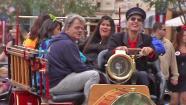 People ride on a trolly during the Monstrous All-Nighter at Disneyland on Friday, May 24, 2013.