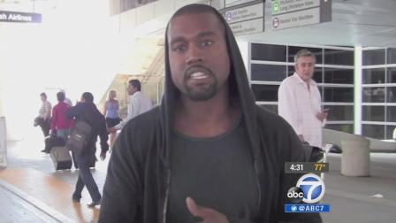 Rapper Kanye West is shown in a confrontation with a celebrity photographer at Los Angeles International Airport on July 19, 2013.k