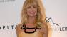 Actress Goldie Hawn poses for photographers as she arrives to a charity dinner for amfAR, a foundation for AIDS research in Rio de Janeiro, Brazil, Friday, Oct. 4, 2013.