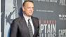 Tom Hanks poses for photographers as he walks the red carpet at a screening for the movie Captain Phillips at the Newseum, Wednesday, Oct. 2, 2013 in Washington.