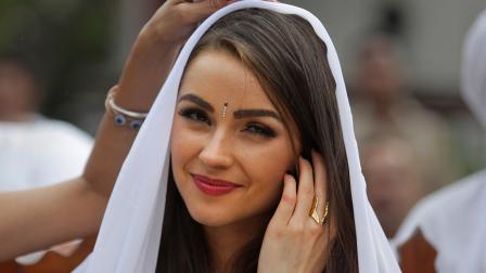 In this, Sept. 30, 2013 file photo, Miss Universe Olivia Culpo, watches a performance by inmates during a visit to the Tihar Jail in New Delhi, India.