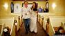 Singer Jon Bon Jovi, left, walks fan Branka Delic, right, down the aisle to give her away at her wedding in Las Vegas on Saturday, Oct. 12, 2013.