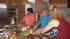 Three women are seen cooking in this undated...