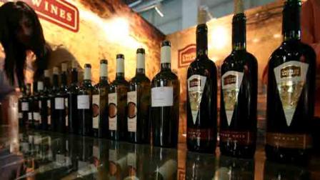 A woman arranges bottles of a red wine during the annual Vinaria 2009 international wine fair in the town of Plovdiv, Bulgaria, Wednesday, March, 18, 2009.