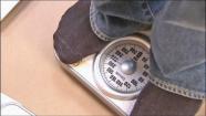 A person is seen weighing themselves in this undated file photo.
