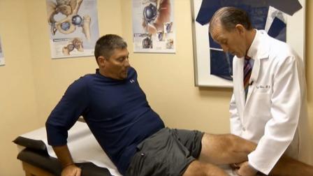 A doctor examines a patients knee in this undated file photo.
