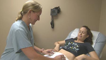 A woman undergoes a pregnancy examination in this file photo from Monday, Dec. 3, 2012.