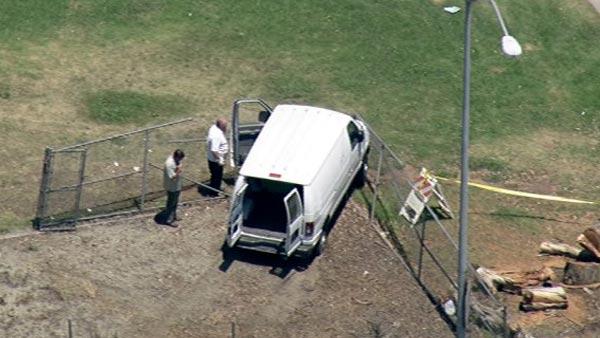 White van crashed into chain link fence