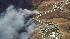 Firefighters battle a fast moving brush fire...