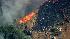 Firefighters battle a fast moving brush fire...