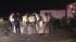 Emergency responders hold up a tarp at the scene...