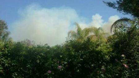 Smoke rises above a brush fire that burned tens of acres in the Lake Mathews area on Sunday, May 27, 2012.