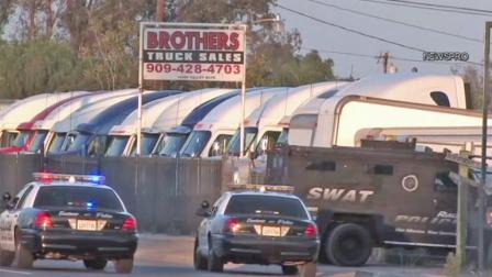 Fontana police patrol cars and a SWAT vehicle surround a trucking yard in Fontana on Saturday, July 14, 2012.