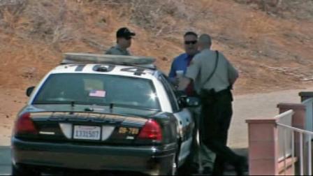 Investigators gather near a sheriffs patrol car near the scene of a deputy-involved shooting in Jurupa Valley on Saturday, July 14, 2012.