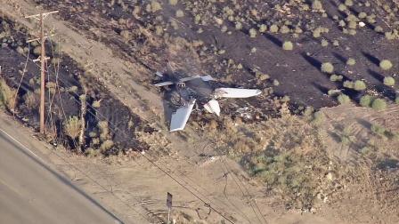 A small plane is seen after it crashed in a field near the Corona Municipal Airport on Friday, July 20, 2012. Two people on board the plane managed to escape with unknown injuries.