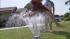 A boy jumps over a sprinkler during a warm summer day on Monday, Aug. 6, 2012.