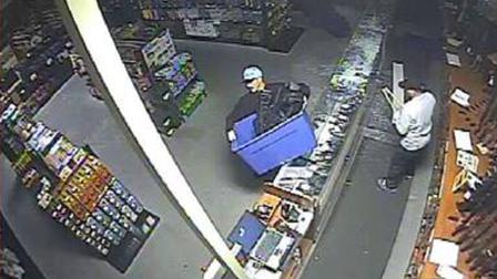 Suspects are shown stealing rifles from a Corona gun shop in this Aug. 14 surveillance image.