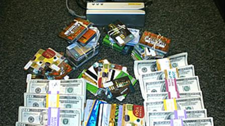 A credit card skimming device, cash and blank credit cards were seized from a Corona mans home on Thursday, Nov. 8, 2012.
