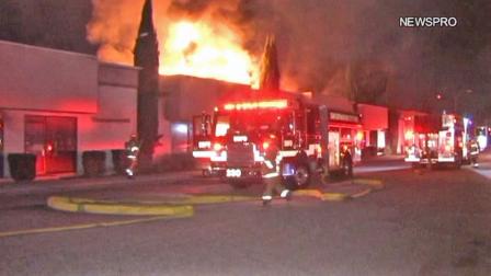Firefighters appear at the scene of a blaze at a strip mall in San Bernardino on Monday, Nov. 19, 2012.