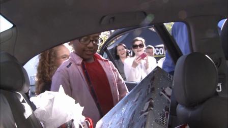 Isaiah Angull, 11, looks at gifts inside a car donated to his family on Thursday, Dec. 20, 2012.
