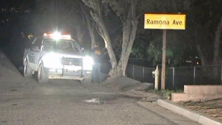 A law enforcement vehicle is shown near the scene where a mother and daughter were murdered in the Nuevo area of Riverside County.