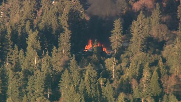 Smoke rises from a burning cabin in the Big Bear area where fugitive murder suspect Chris Dorner was believed to be holed up on Tuesday, Feb. 12, 2013.