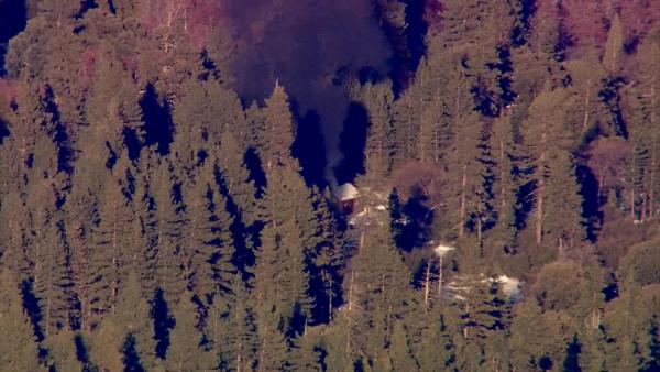 Smoke rises from a burning cabin in the Big Bear area where fugitive murder suspect Chris Dorner was believed to be holed up on Tuesday, Feb. 12, 2013.