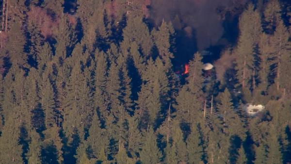 Smoke rises from a burning cabin in the Big Bear area where fugitive murder suspect Chris Dorner was believed to be holed up on Tuesday, Feb. 12, 2013.