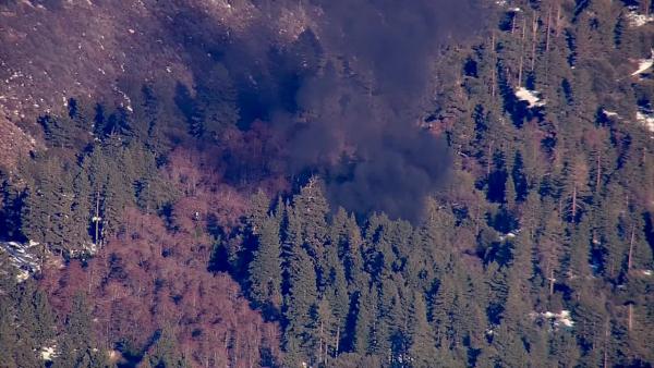 Smoke rises from a burning cabin in the Big Bear area where fugitive murder suspect Chris Dorner was believed to be holed up on Tuesday, Feb. 12, 2013.