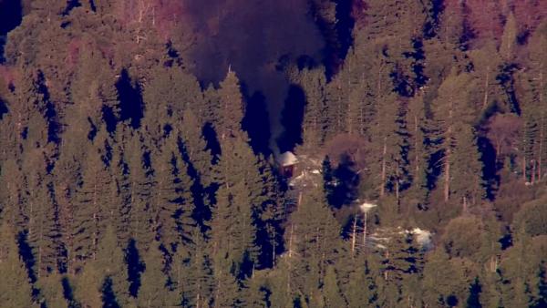 Smoke rises from a burning cabin in the Big Bear area where fugitive murder suspect Chris Dorner was believed to be holed up on Tuesday, Feb. 12, 2013.