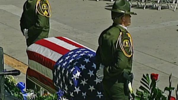 The flag-draped coffin of San Bernardino County Sheriff's Detective Jeremiah MacKay is seen at his funeral service on Thursday, Feb. 21, 2013.