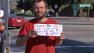 Jesse Hale holds up a sign he uses while panhandling in San Bernardino on Monday, Feb. 25, 2013.