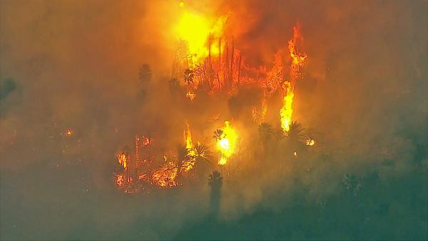A brush fire is seen in a riverbed in Jurupa Valley on Thursday, Feb. 28, 2013.