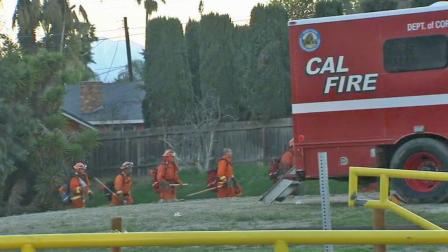 Firefighters work to put out a brush fire in a riverbed in Jurupa Valley on Friday, March 1, 2013.