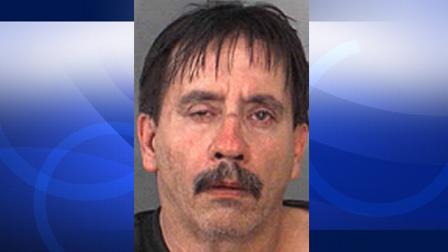 Michael Cross, 51, is seen in a booking photo. He is accused of heading a scam to get money from elderly residents in the Inland Empire.