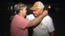 Two neighbors embrace each other after flames from a brush fire came dangerously close to homes in Banning on Wednesday, May 1, 2013.